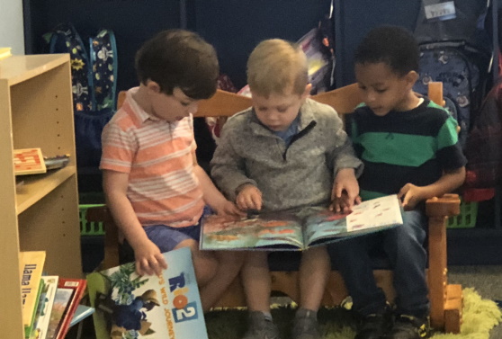 Three preschool boys reading together for March Madness Reading Challenge