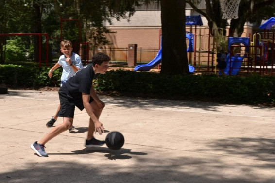 Two middle school boys playing basketball