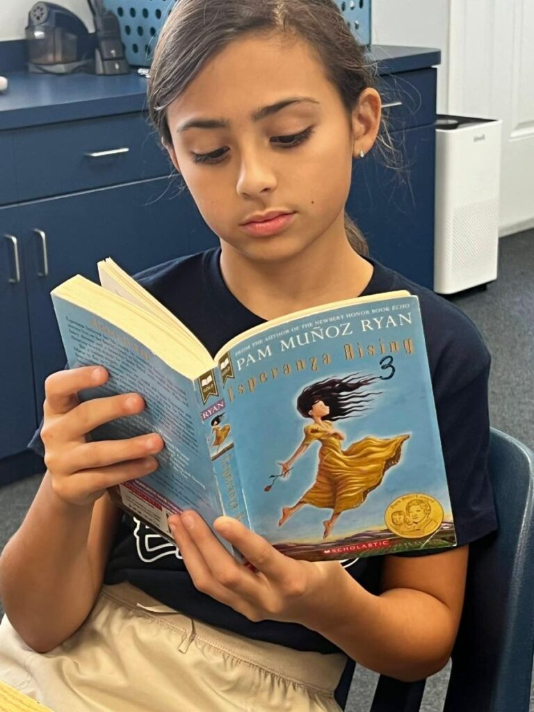 Elementary girl student reading book