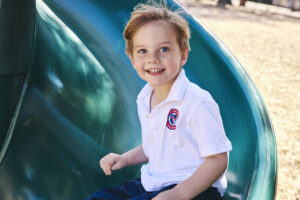 Preschooler on playground slide