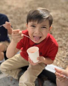 Small boy eating shaved ice
